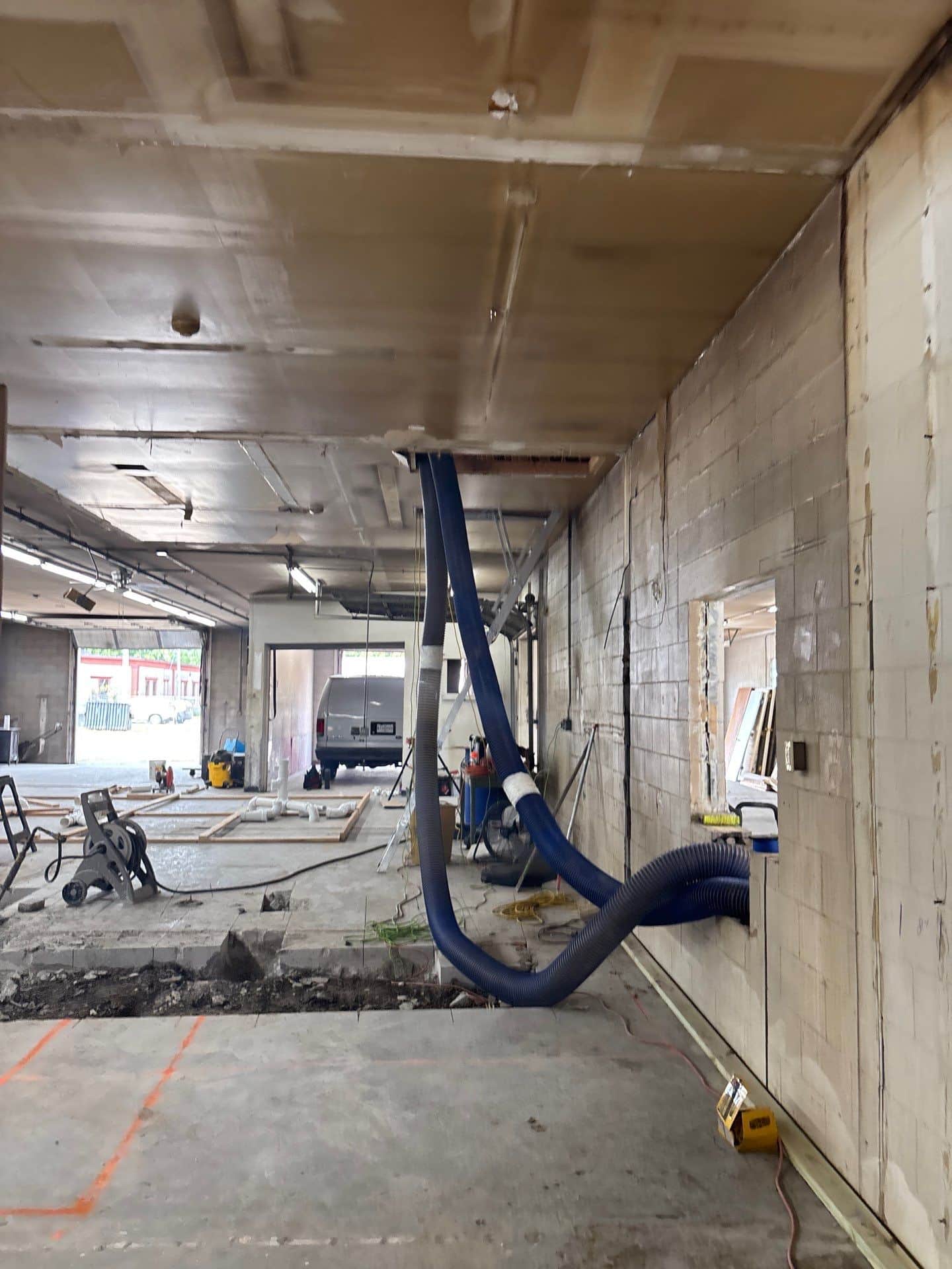 pipes going from ceiling out a window removing insulation