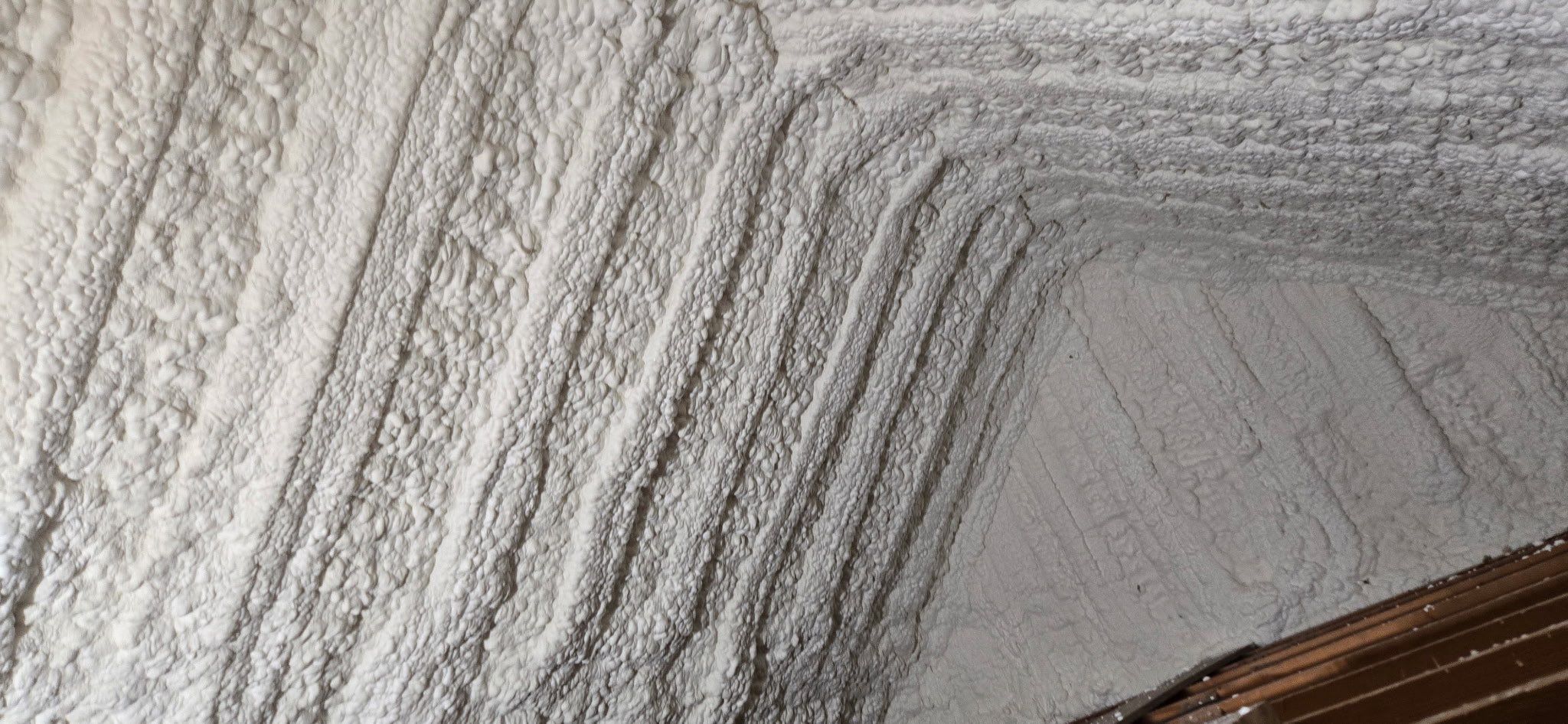 spray foam sealing up the attic ceiling