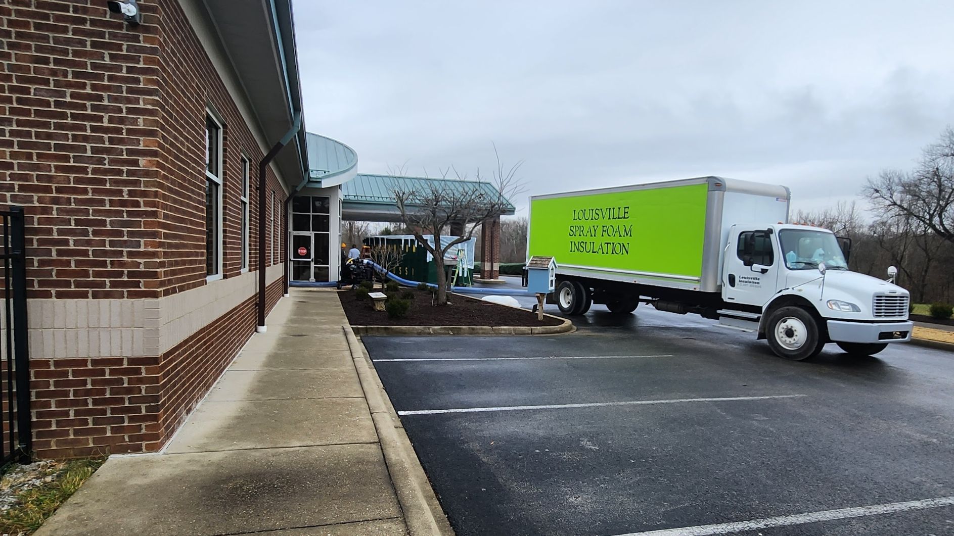 Louisville Insulation truck parked outside of Down Syndrome of Louisville